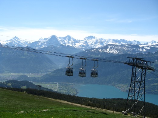 Cablecar ascending with Bernese Alps in background.
